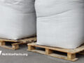 bags of sugar on palettes in a warehouse