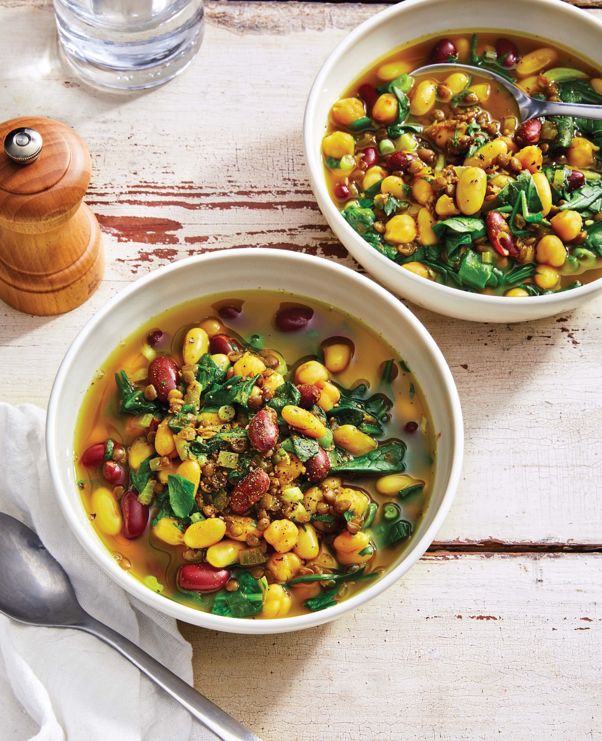 ceramic bowls filled with three bean soup and greens